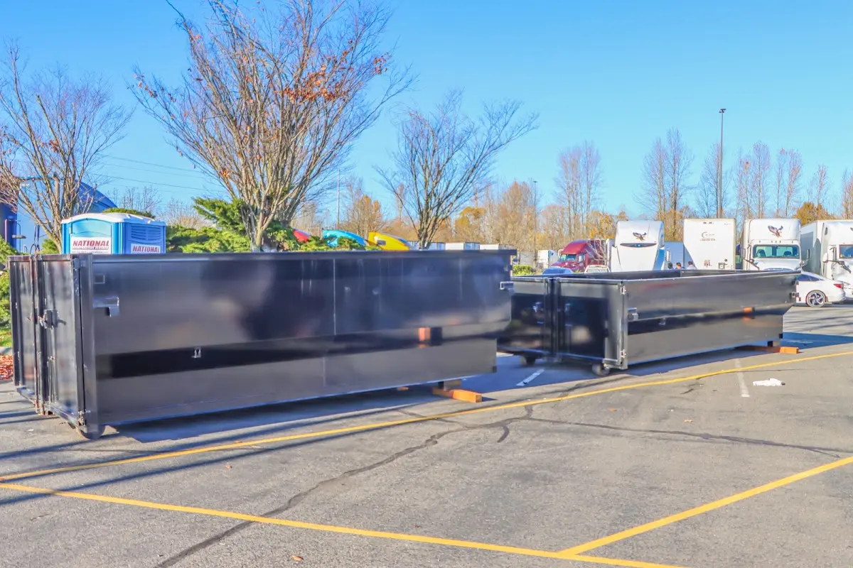 Professional dumpster rental service with roll-off container on residential driveway in Madera Ranchos